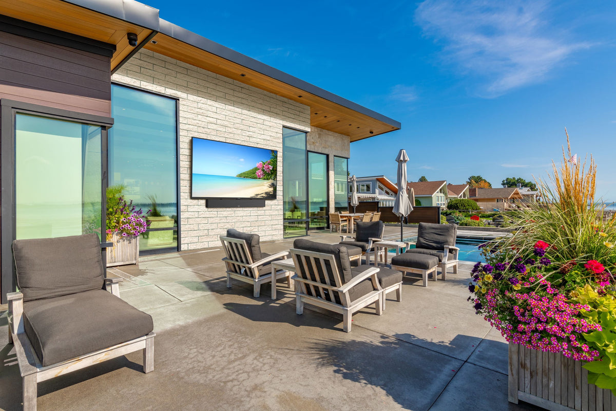 Peerless-AV BWPTV554 outdoor TV installed on patio with soundbar