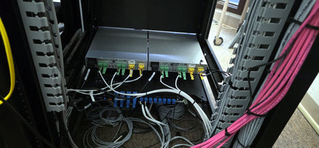 Two Biamp Tesira AMP-A460H four-channel amplifiers installed in the audio rack of the Placer County Board of Supervisors chamber in Auburn, California.