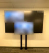 A Samsung QB98T-B 98-inch display on a Chief XBM1U bolt-down floor mount in the Tailored Brands training room in Dublin, California, during a test call.