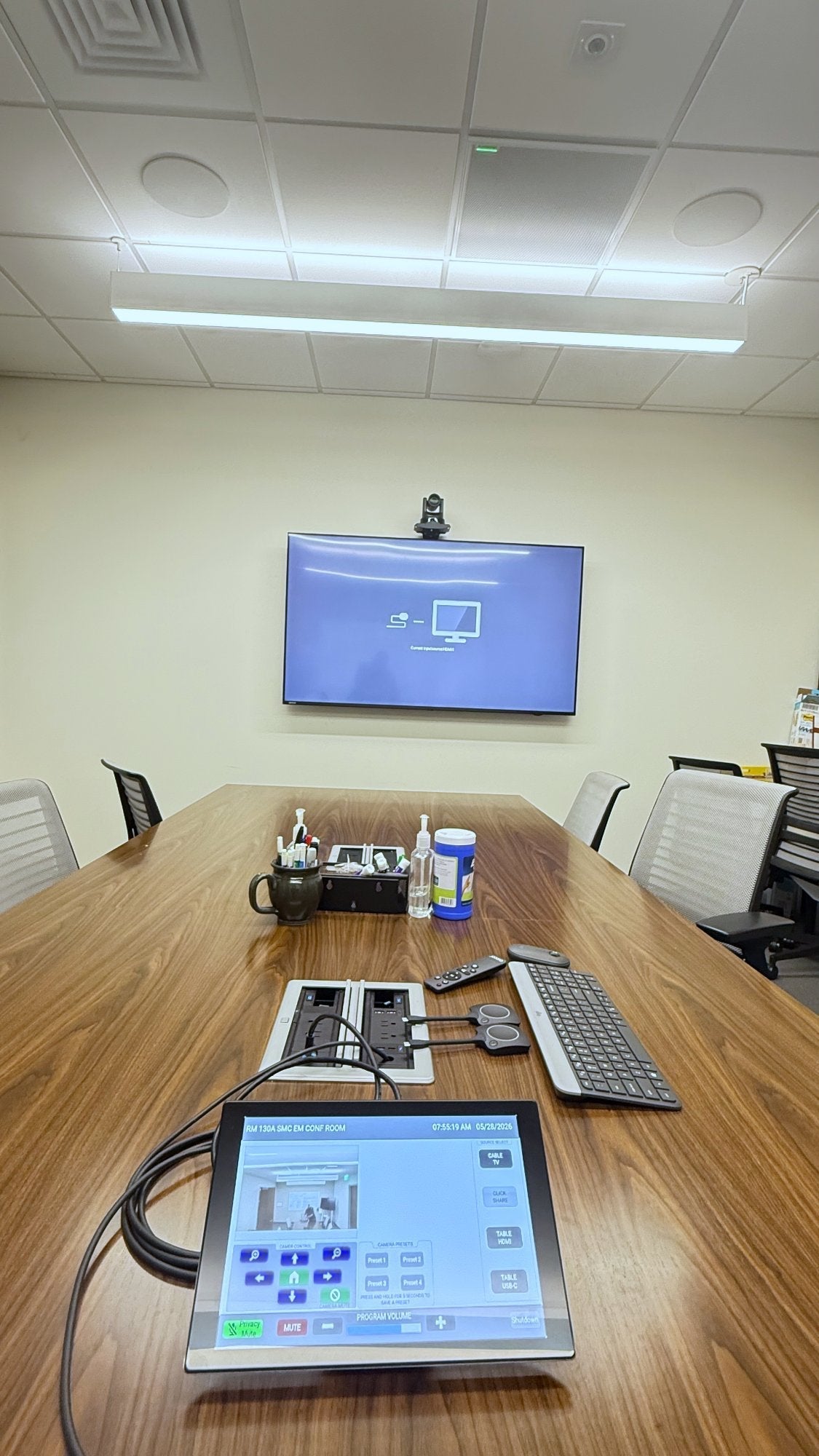 County of San Mateo emergency management conference room 130A in Redwood City, California, with a QSC TSC-101-G3 touch panel on the table, a 75 inch Avocor display and a QSC NC-12x80 PTZ camera.