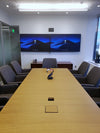 A Segment conference room in San Francisco, California, with dual wall-mounted displays seen from the end of a long table.