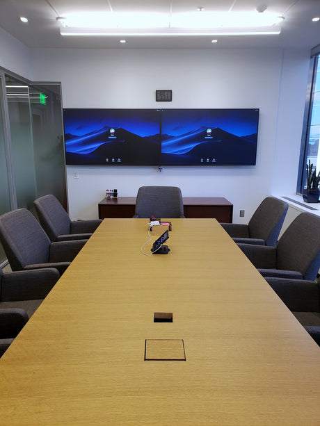 A Segment conference room in San Francisco, California, with dual wall-mounted displays seen from the end of a long table.