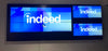 A Planar Clarity Matrix MX46HDX video wall showing the Indeed logo at Indeed's 1301 2nd Avenue office in Seattle, Washington, during commissioning.