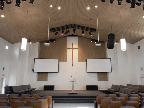 Interior of a church with a cross, pulpit, and seating.
