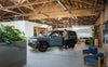 A modern vehicle displayed in a spacious, stylish indoor environment with plants.