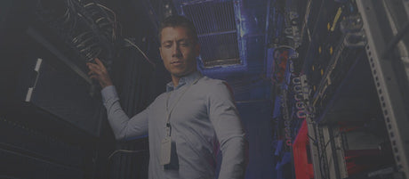 Person in a  avoip server room, interacting with equipment.