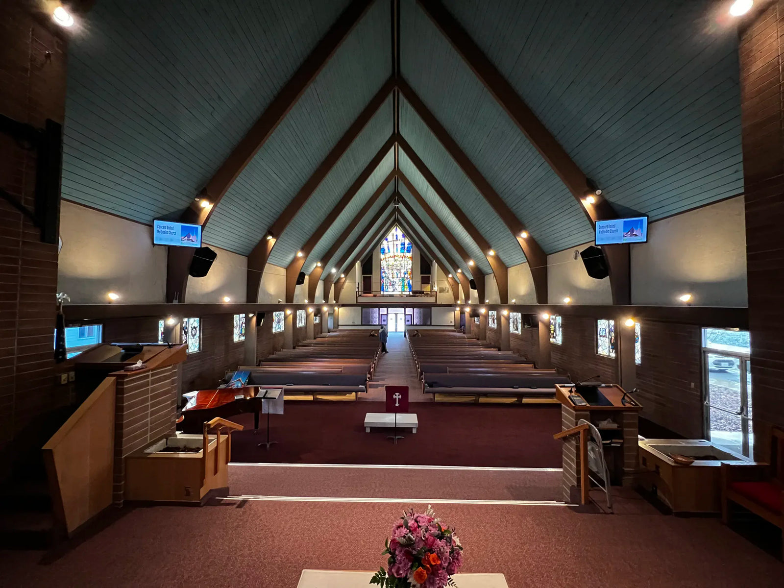 Interior view of a church with a central aisle and decorative elements.