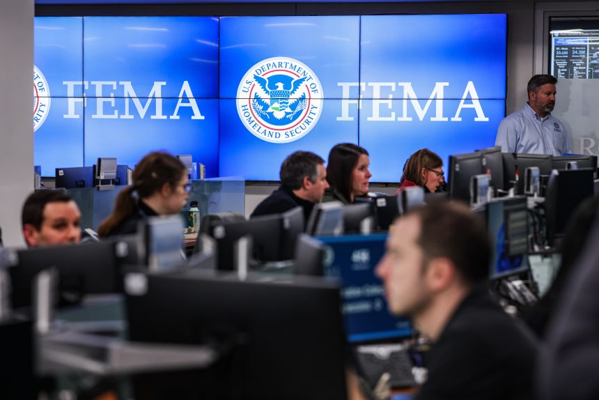 People working at computers in a FEMA operations center.