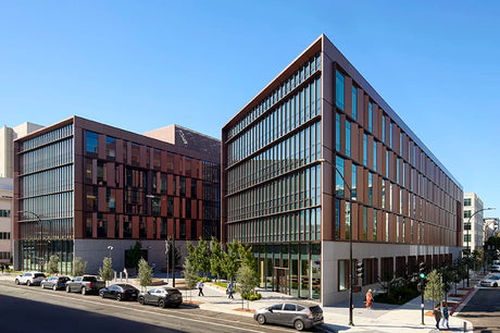 Modern buildings with glass facades on a city street.