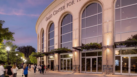 Grand Center for the Arts at dusk with people walking outside.