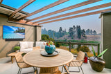 Peerless-AV Neptune NTSB150 outdoor soundbar under outdoor TV, full sun patio